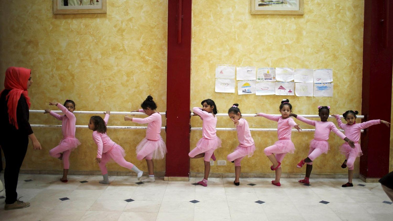 Palestinian girls take part in a ballet dancing course, run by the Al-Qattan Center for Children, in Gaza City